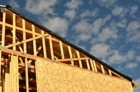 New home under construction with clouds and blue sky Stock Photos
