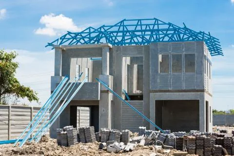 New home under construction using steel frames against cloudy sky Stock Photos