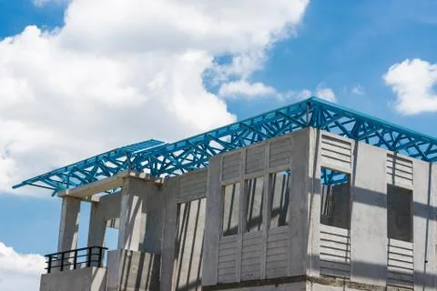 New home under construction using steel frames against cloudy sky Stock Photos