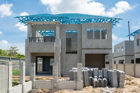 New home under construction using steel frames against cloudy sky Stock Photos