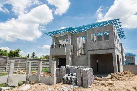 New home under construction using steel frames against cloudy sky Stock Photos
