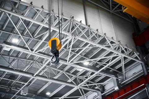 New hook assembly with yellow roller of moving crane Stock Photos