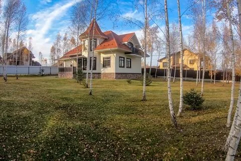 New house with plot planted with birch trees. Beautiful home own Stock Photos