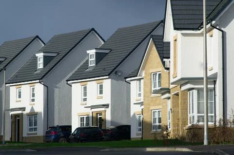 New housing development under dark storm clouds Stock Photos