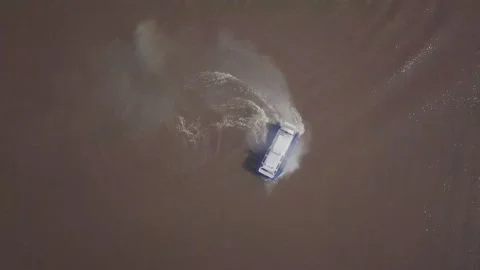 New hovercraft with large white propeller rotates on river Stock Footage 155286775