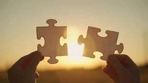 New idea and system. Slow-motion female hands assemble a puzzle against the Stock Footage 157789405