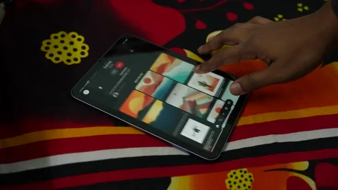 The new ipad mini with vibrant display on top of a colorful bed sheet Stock Footage 167762939