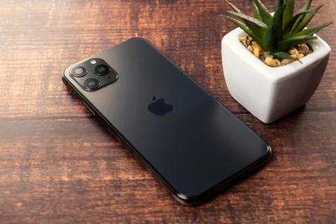 New Iphone 11 Pro Max on wooden table Фото