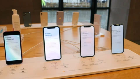 New iPhone 12 and iPhone 12 Pro on display during launch day next to SE and 11 Stock Footage 141773696