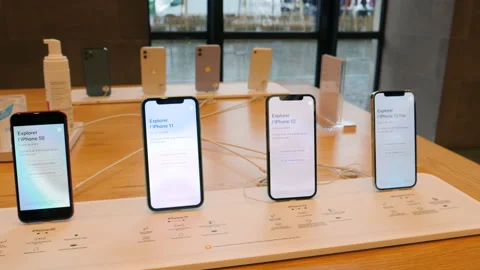 New iPhone 12 and iPhone 12 Pro on display during launch day next to SE and 11 Video stock 142108658