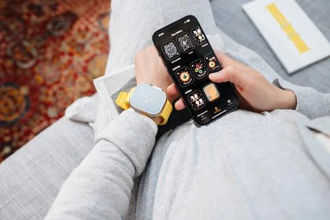 New iPhone 14 Pro wearing new Apple Watch Series Ultra on her wr Stock Photos