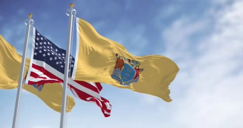 New Jersey state flags waving with the american flag on a clear day Video stock 259315241