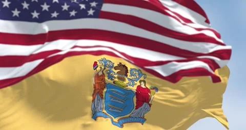 New Jersey state flags waving with the american flag on a clear day Video stock 269358257