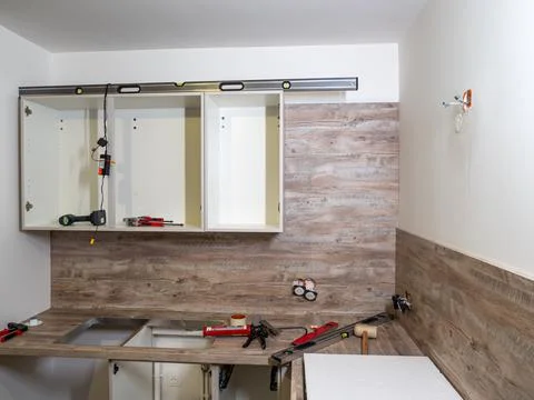 New kitchen - prepared for the assembly of kitchen furniture, cabinets, sink, Stock Photos