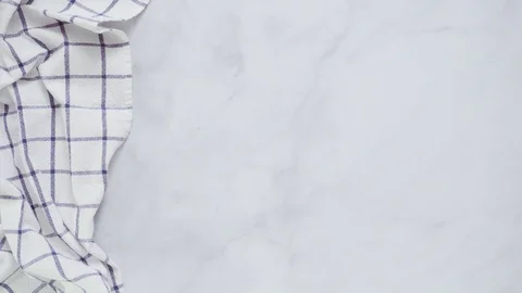 New kitchen towels with simple blue pattern folded on marble counter. Stock Footage 93412740