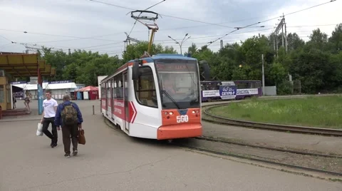 New KTM tram in advertising livery starts from a loop terminus Stock Footage 64638853
