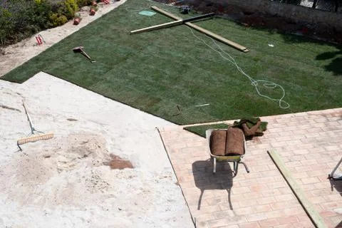 New lawn being created with rolls of turf Stock Photos