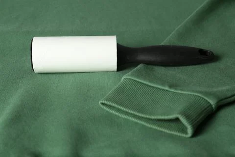 New lint roller with black handle on green sweatshirt Photos