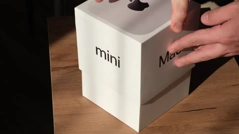 New M4 Mac mini being unboxed. Modern Apple packaging with premium Stock Footage 307666531