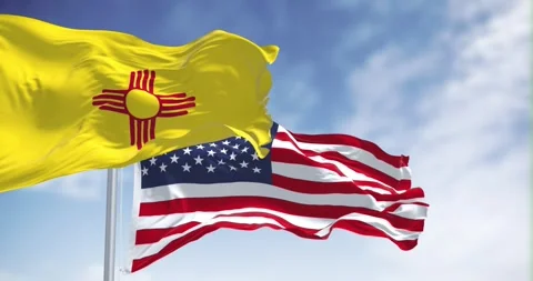 New Mexico state flag waving with the american flag ion a clear day Stock Footage 253277789