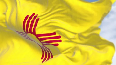 New Mexico state flag waving with red Zia sun symbol on yellow background Stock Footage 305753183
