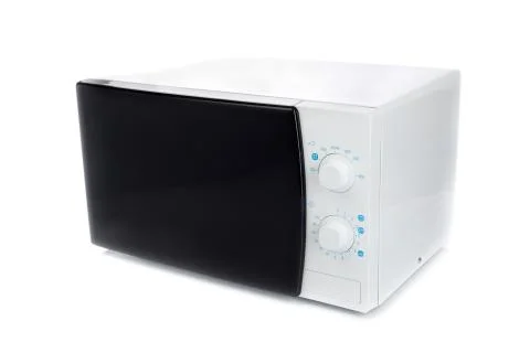 New microwave oven with analog control. Stock Photos