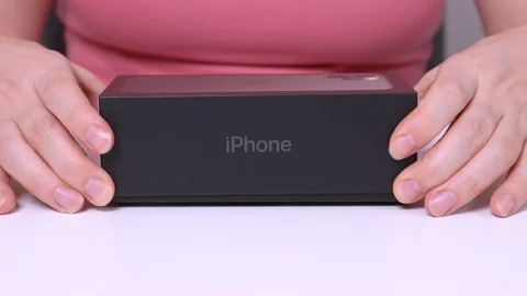 New midnight green Apple iPhone 11 Pro lifts it up, unpacking Video stock 130122559