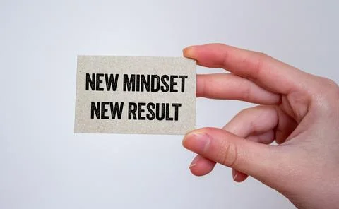 New mindset new result message written on a card in hand. Conceptual new mi.. Stock Photos