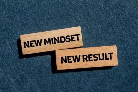 New mindset new result message written on wooden blocks on gray background... Stock Photos