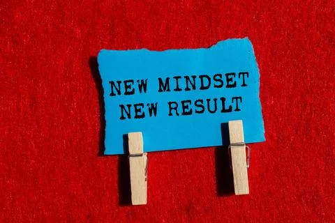 New mindset new result message written on ripped torn blue paper piece on b.. Stock Photos