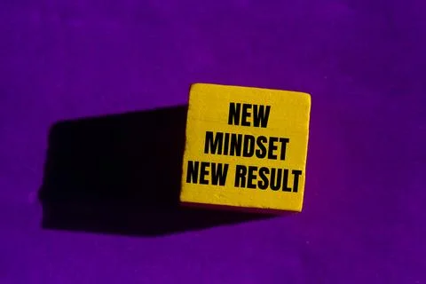 New mindset new result message written on yellow wooden cube on purple back.. Stock Photos