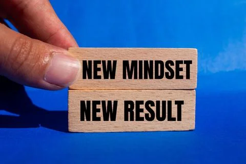 New mindset new result message written on wooden blocks on blue background... Stock Photos
