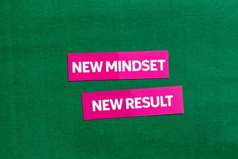 New mindset new result message written on pink stickers on green background.. Stock Photos