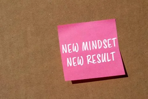 New mindset new result message written on pink paper on brown background. C.. Stock Photos