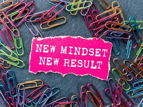 New mindset new result message written on ripped torn pink paper piece on g.. Stock Photos