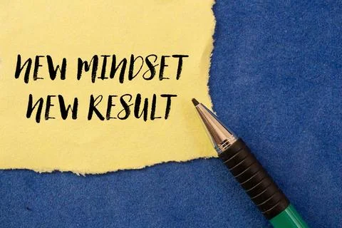 New mindset new result message written on ripped torn yellow paper on blue .. Stock Photos
