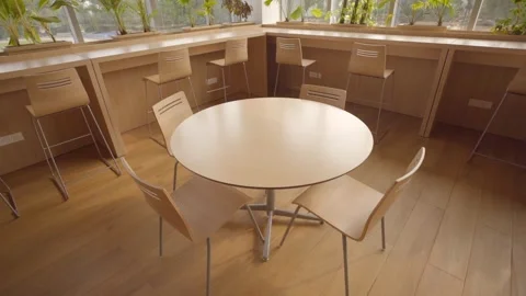A new modern cafe corner with round table wooden chairs high stools Stock Footage 334113074