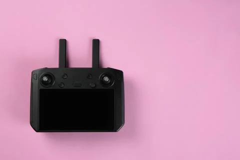 New modern drone controller on pink background, top view. Space for text Stock Photos