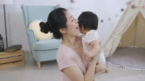 New mom is giving her active lovely baby Video stock 158674029