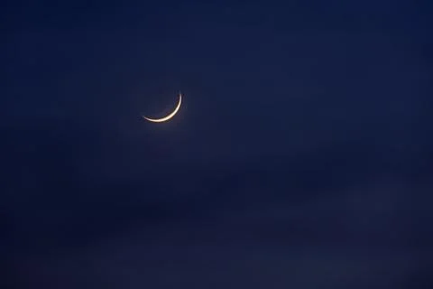 New moon in the initial phase on a dark night sky Foto stock