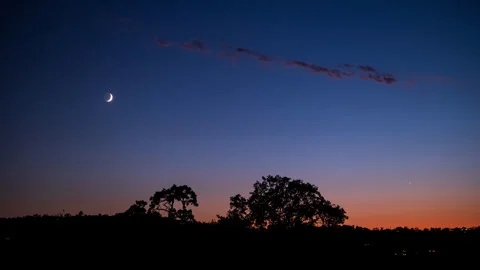 New Moon Sets in Orange Blue Sunset Stock Footage 283930859