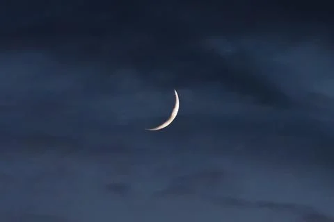 The new moon through the clouds Stock Photos