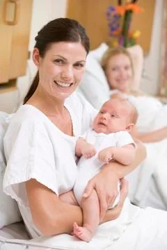 New mother with baby in hospital smiling Stock Photos