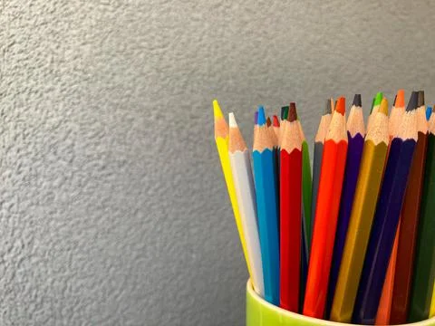 New multi-colored drawing pencils stand on a white background Stock Photos