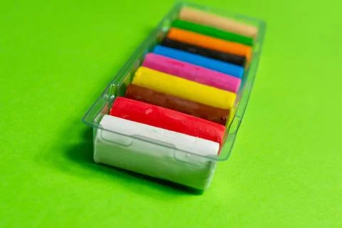New multi-colored plasticine on a green background. isolate. Фото