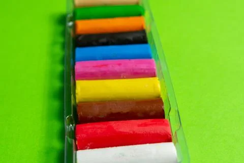 New multi-colored plasticine on a green background. Stock Photos