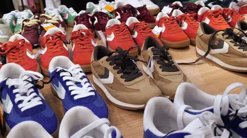 New multi-colored sneakers standing in a row in a clothing store. Stock Footage 301245288