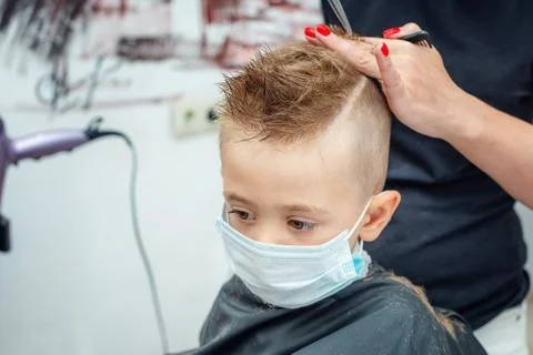 New normal adapting to normal life after pandemic lockdown. boy getting hair cut Foto stock