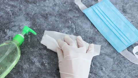 The new normal after covid-19, hand using disinfectant wipe to clean concrete Stock Footage 136138566
