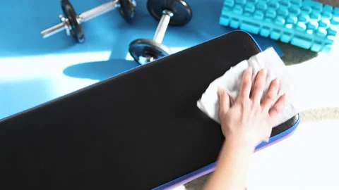 The new normal after covid-19, hand cleaning gym equipment with disinfectant  Stock Footage 136138678